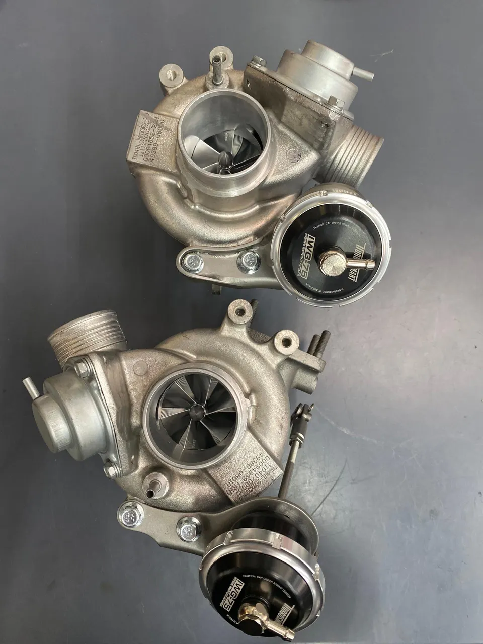 Two performance turbochargers with Third Party wastegates on a dark background, ready for installation.