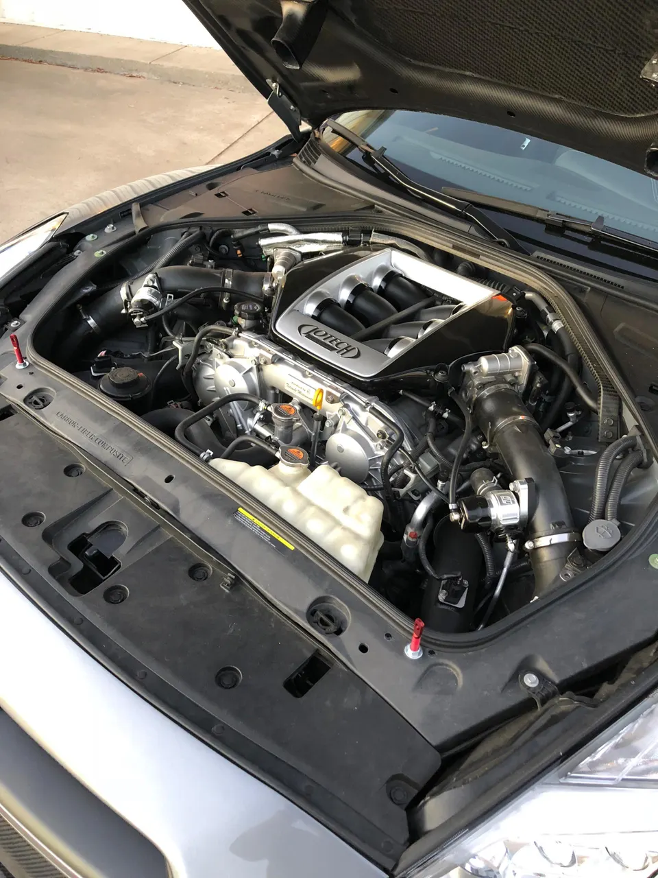 Close-up view of a Jotech-tuned Nissan GT-R R35 VR38DETT engine bay with custom intake manifold.
