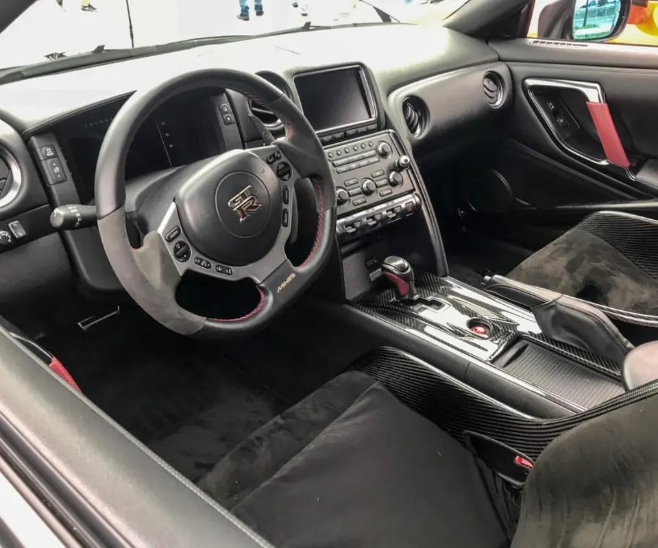 Nissan GT-R interior with custom steering wheel, carbon fiber trim, and alcantara seats