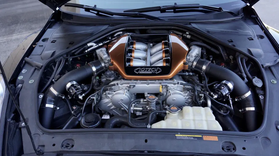Close-up view of a Jotech tuned Nissan GT-R engine bay featuring a custom intake manifold and boost piping.