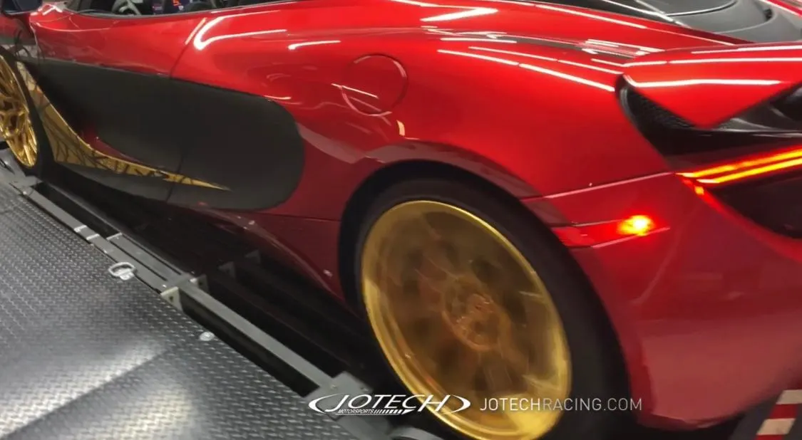 Red McLaren supercar with gold wheels on a Jotech Motorsports dyno during a performance test.