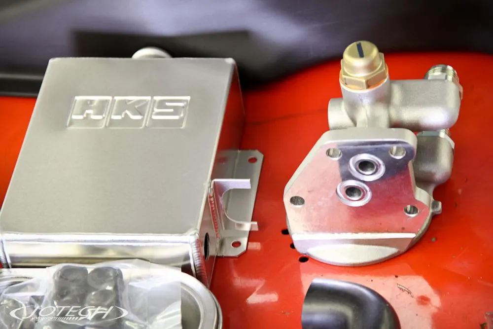 HKS oil catch can and oil filter relocation kit for a performance build.