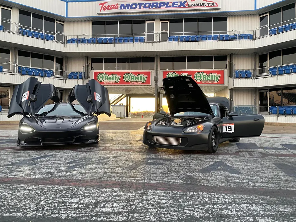 McLaren 720S and Honda S2000 with open hoods and doors at Texas Motorplex drag strip.