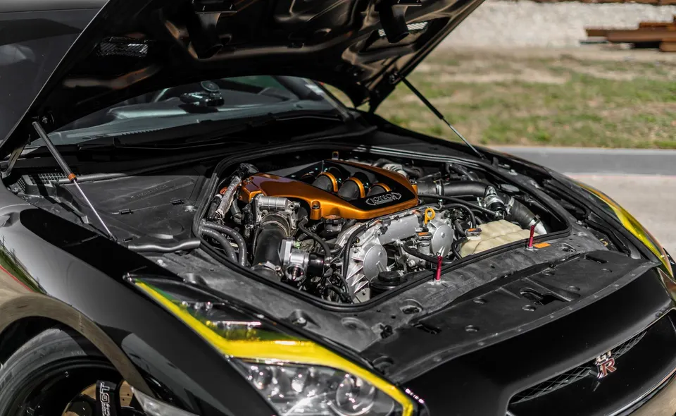 Close-up of a Jotech-built Nissan GT-R VR38DETT engine bay with custom bronze intake manifold