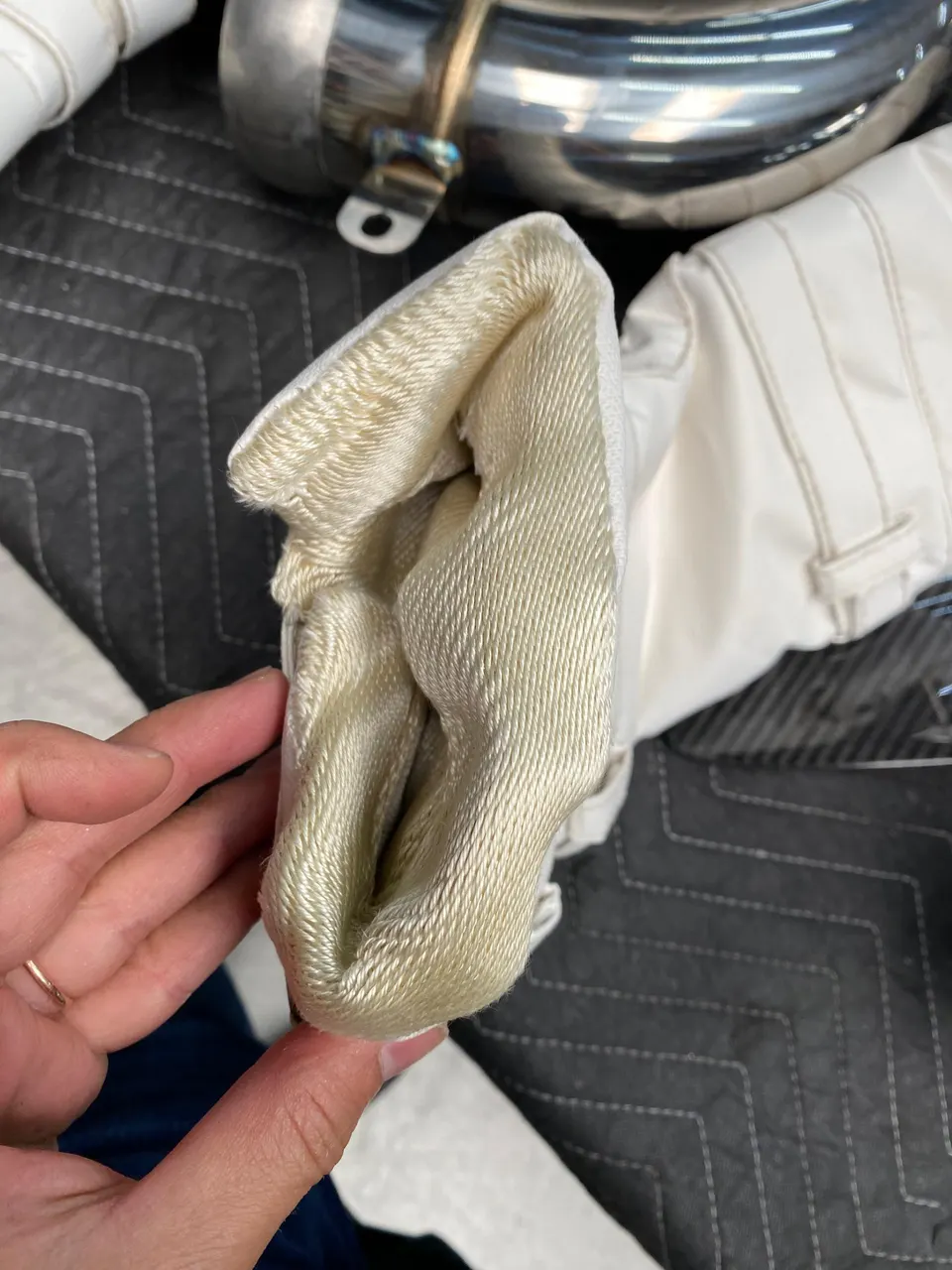 Close-up of a thermal blanket for a performance car part, likely for a turbocharger or exhaust system.