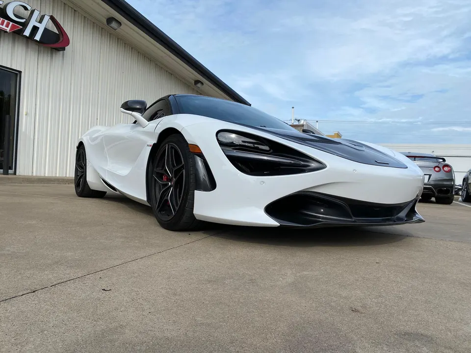 White McLaren 720S supercar parked outside Jotech Motorsports performance tuning shop.