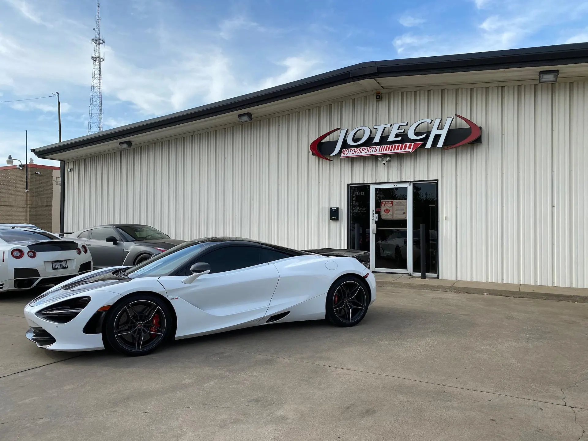 White McLaren 720S and two Nissan GT-Rs parked outside Jotech Motorsports performance tuning shop.