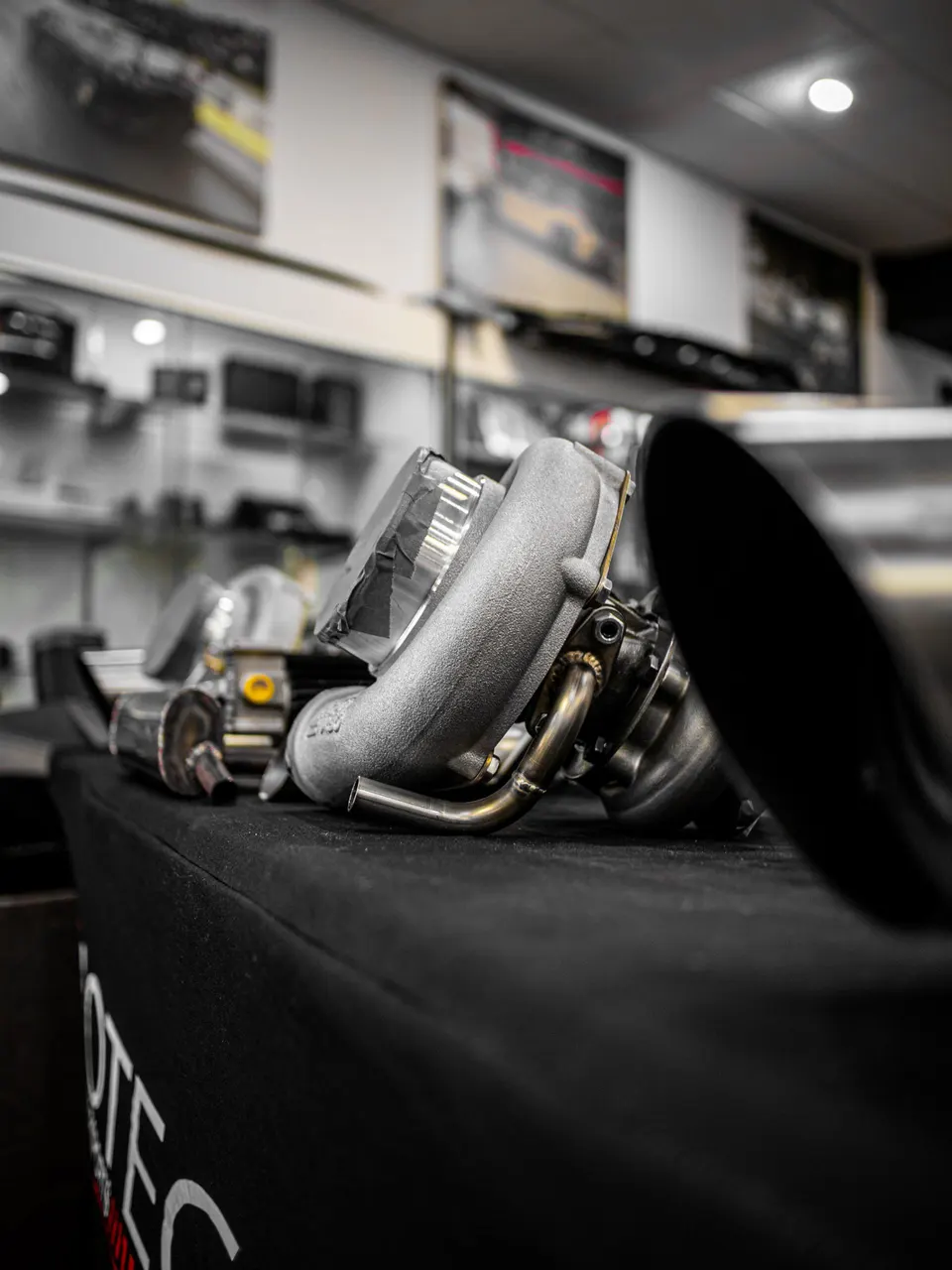 A high-performance turbocharger on display at Jotech Motorsports, a performance tuning shop.