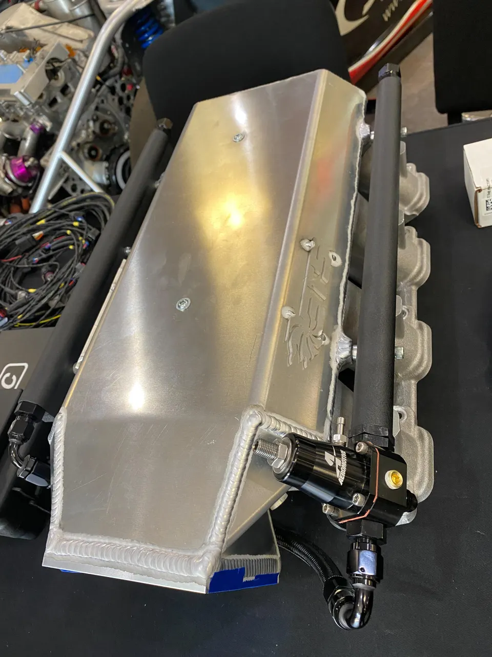 Custom fabricated aluminum intake manifold with Aeromotive fuel rails and regulator for a high-performance engine.
