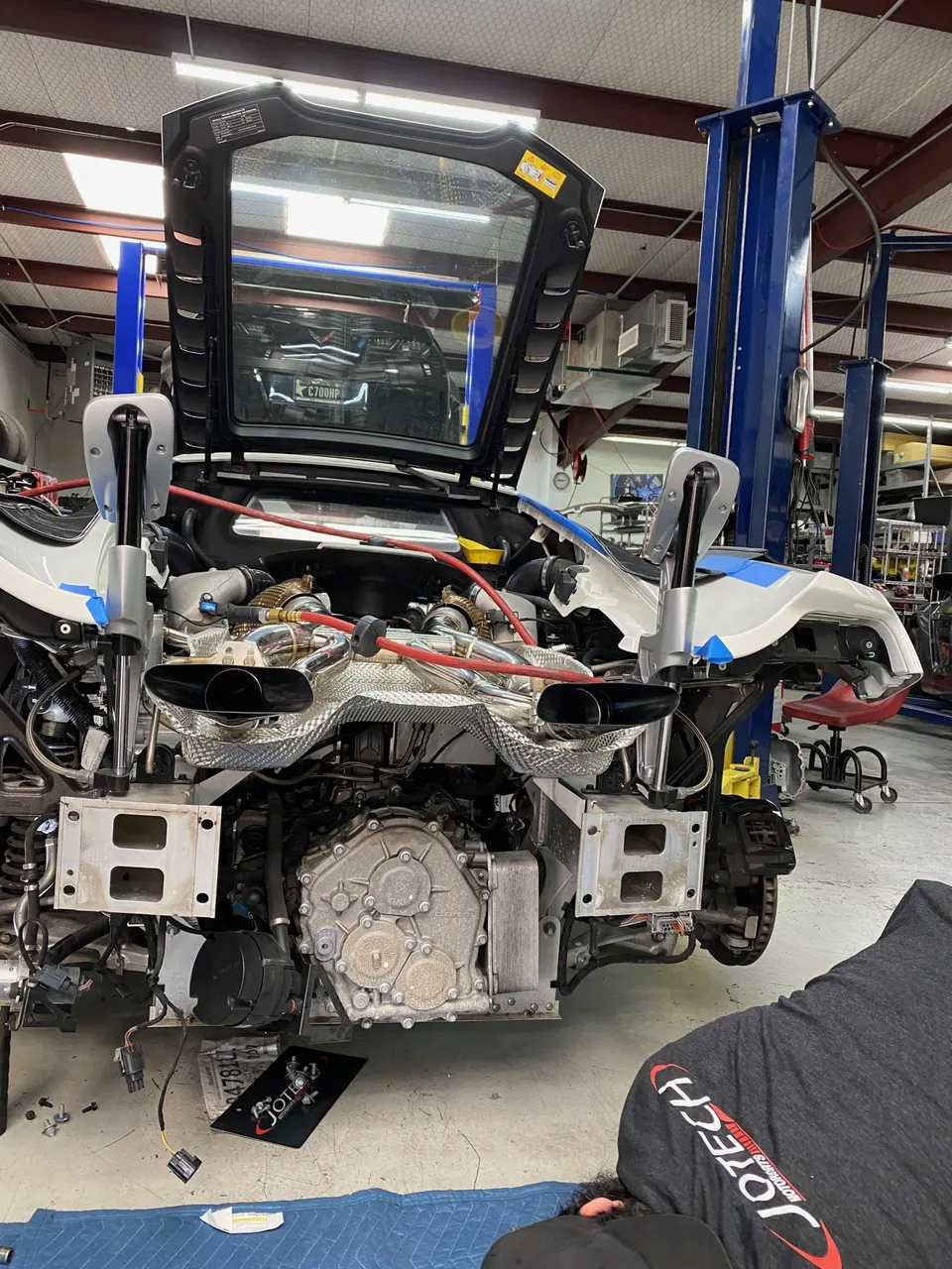 McLaren supercar undergoing extensive engine and drivetrain work in a Jotech Motorsports shop.