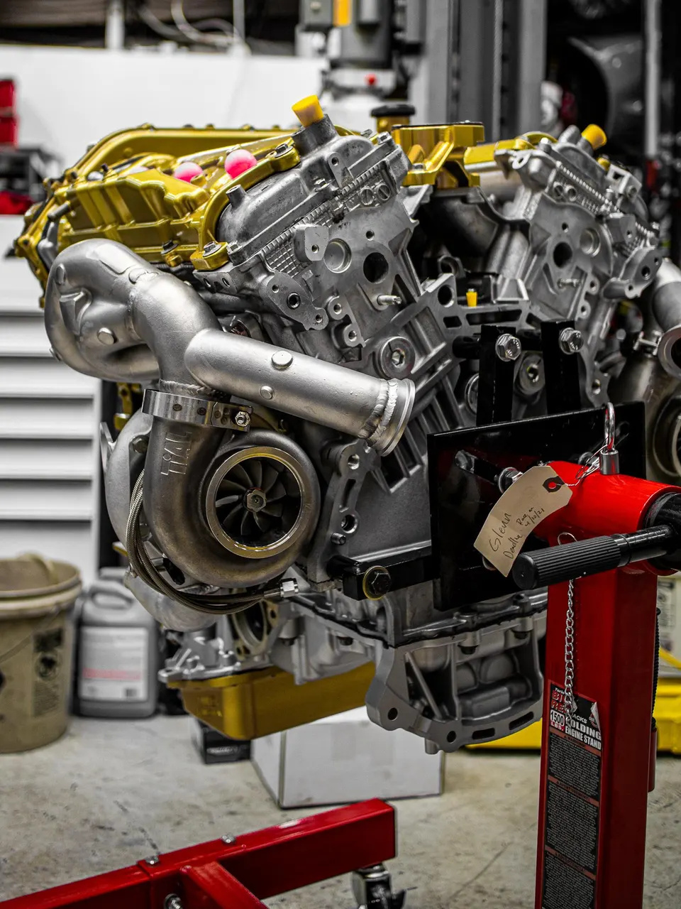 Built engine with turbocharger on an engine stand in a performance shop.