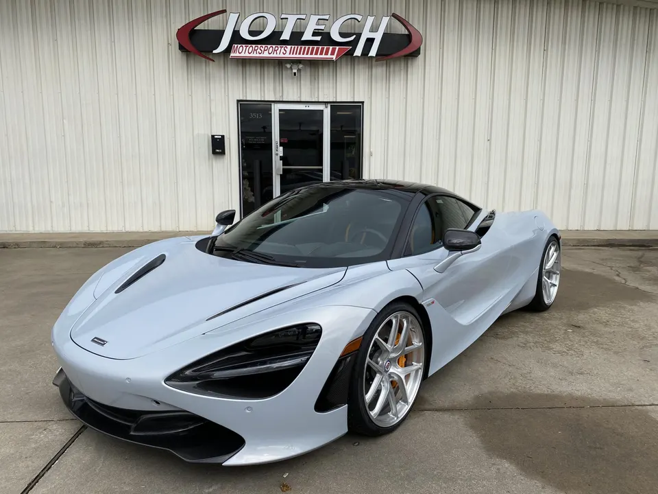 A silver McLaren 720S supercar parked outside the Jotech Motorsports performance tuning shop.