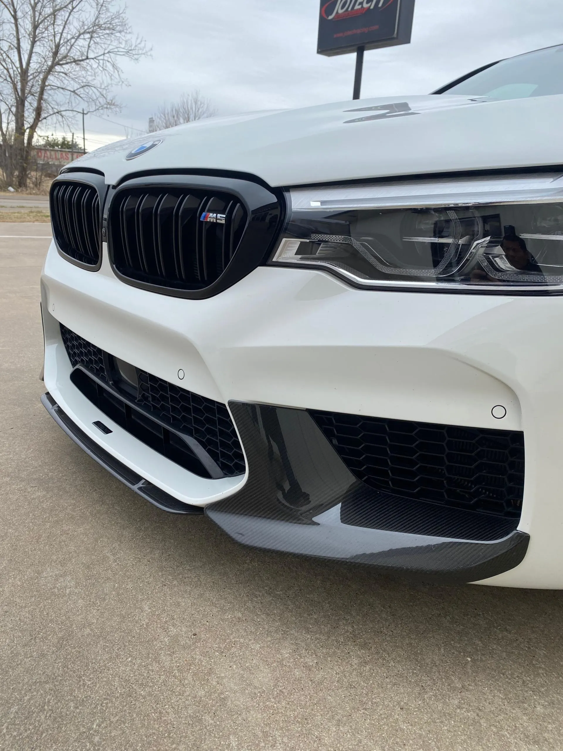 White BMW M5 with black kidney grilles and carbon fiber front splitter at Jotech Motorsports.