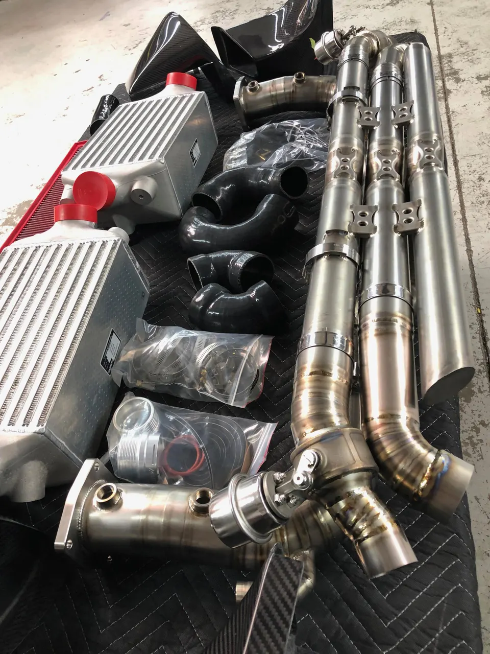 Performance turbo and exhaust components including intercoolers, downpipes, boost piping, and wastegate for a high-horsepower build.