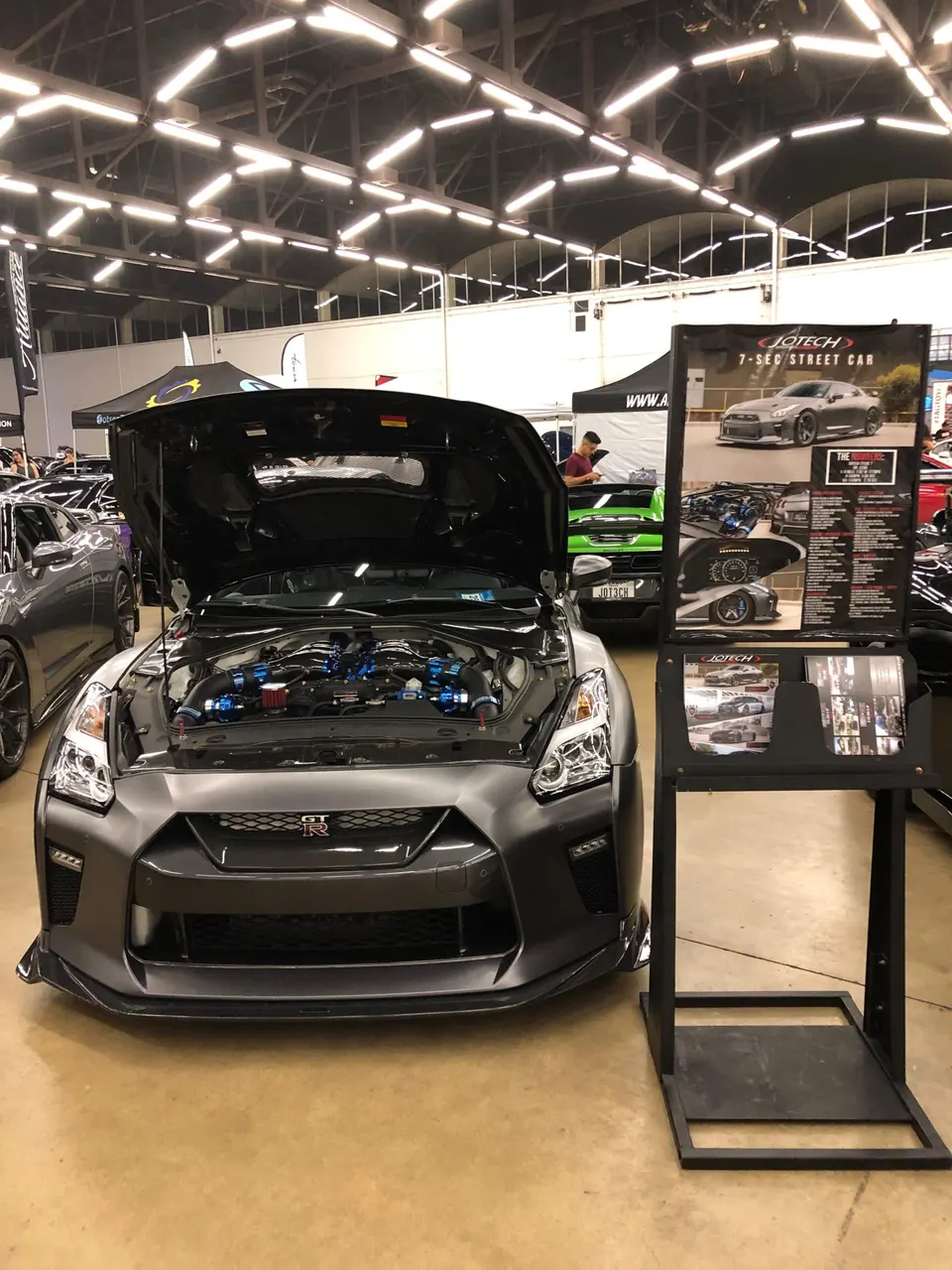 Jotech Motorsports built Nissan GT-R with hood open showcasing the custom engine bay at a car show.