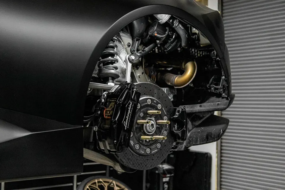 Lamborghini Huracan with carbon ceramic brakes and suspension exposed in a shop setting