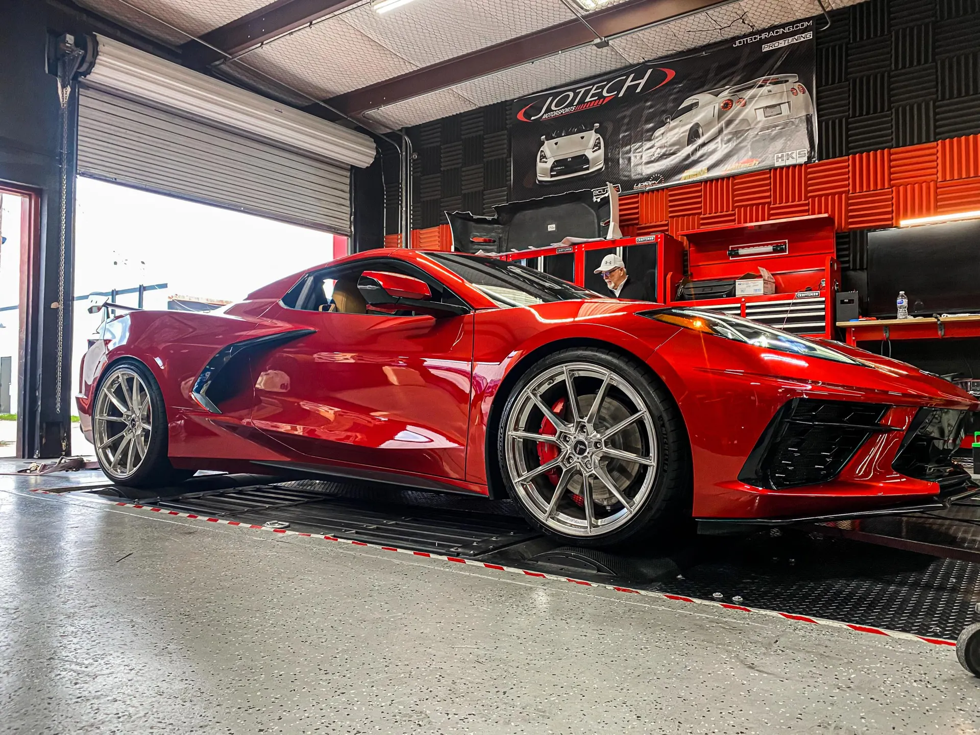 Red C8 Corvette on a dyno at Jotech Motorsports performance tuning shop.