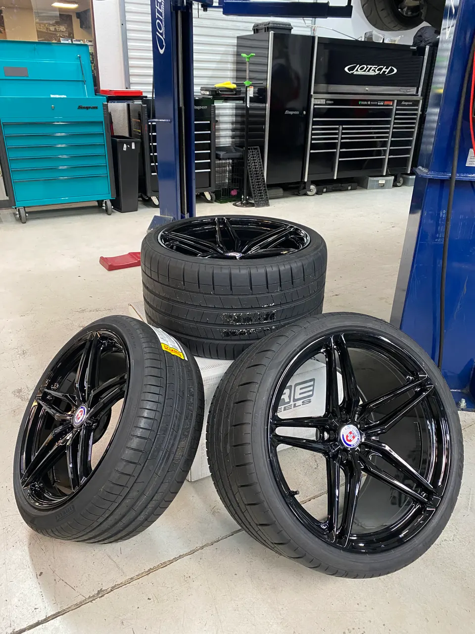 New HRE performance wheels with Pirelli tires in a Jotech Motorsports shop environment, ready for installation