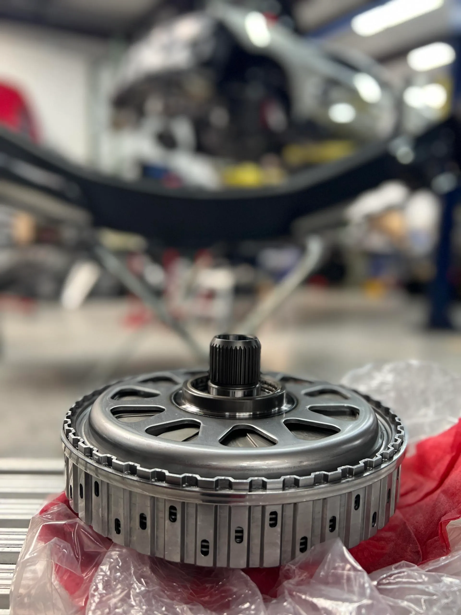 Close-up of a performance transmission component on a workbench in a Jotech Motorsports shop.