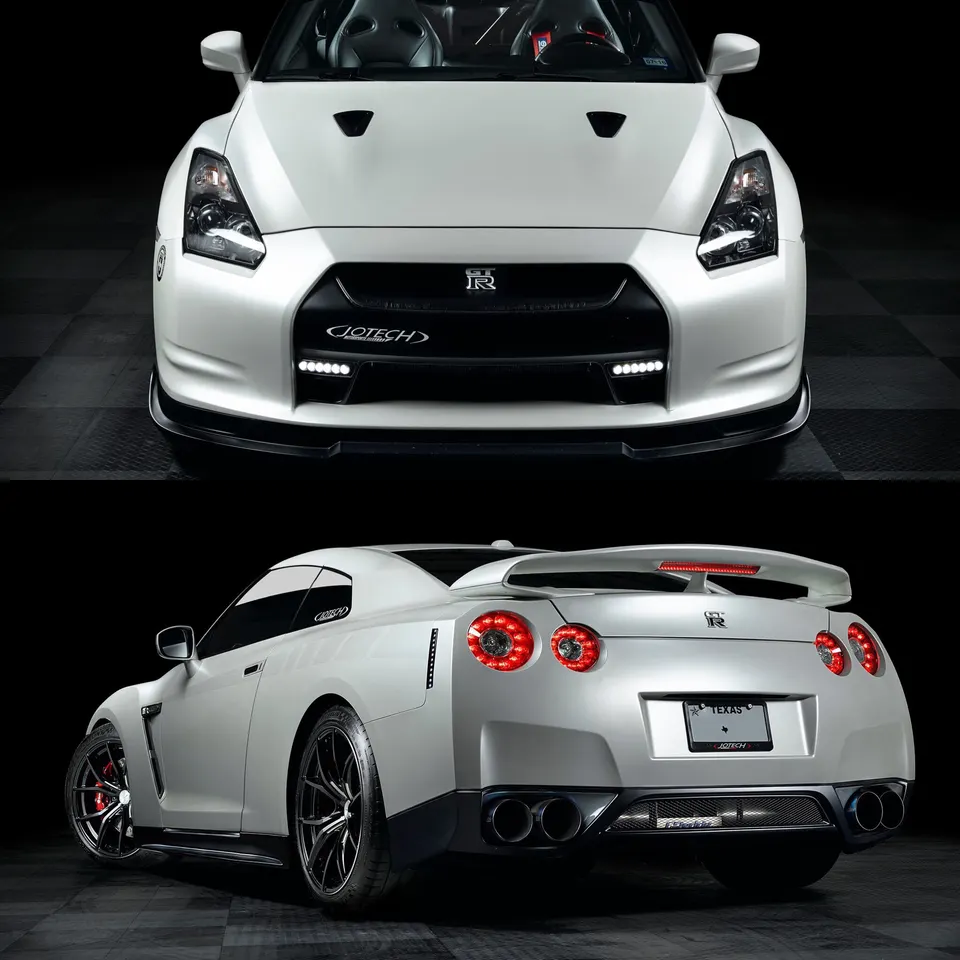 A white Nissan GT-R with Jotech modifications, featuring a front splitter, custom wheels, and quad exhaust tips, professionally photographed.