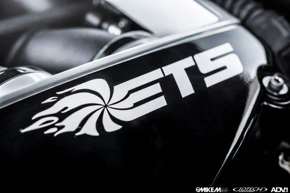 Close-up of a black ETS performance part with a white logo, likely an intercooler pipe or intake component.