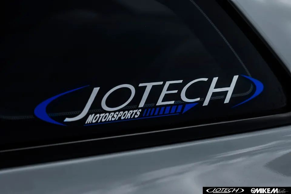 Jotech Motorsports decal on the rear window of a performance car.