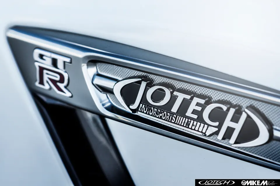 Close-up of a Nissan GT-R fender badge featuring the Jotech Motorsports logo.