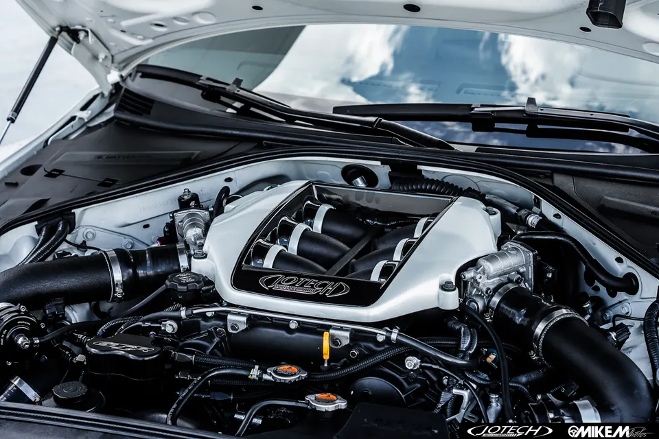 A detailed shot of a Jotech tuned engine bay, showcasing the custom intake manifold and induction system.