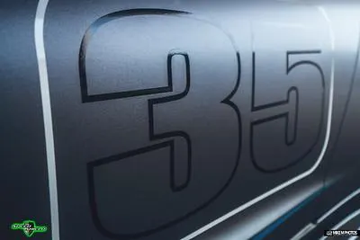 Close-up of the number 35 on the side of a performance car with a matte finish.