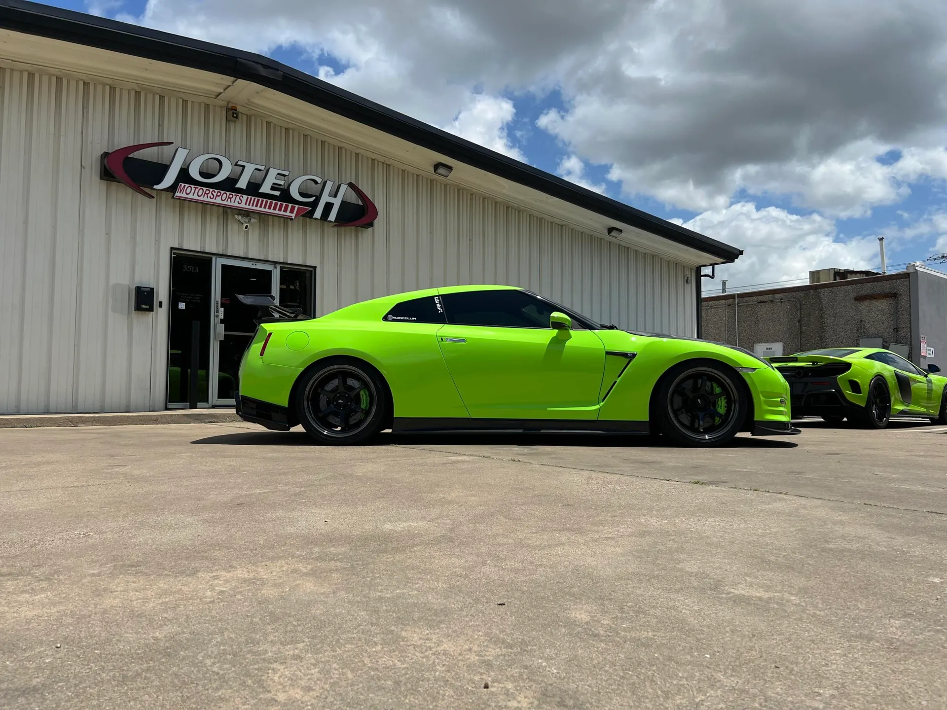 Lime green Nissan GT-R and McLaren parked outside Jotech Motorsports performance tuning shop in Garland, TX.