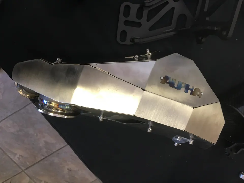 Alpha Performance titanium intake manifold on display, a high-performance aftermarket engine part.