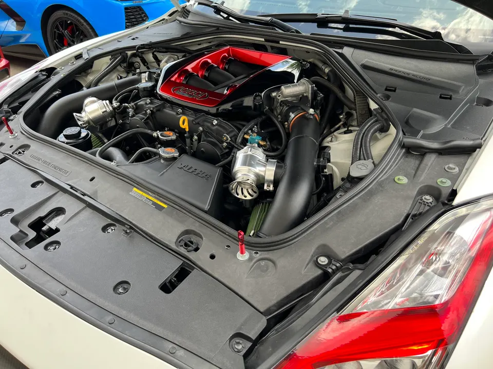 Detailed view of a Jotech-built Nissan GT-R engine bay featuring an Alpha Performance intake and turbo system.