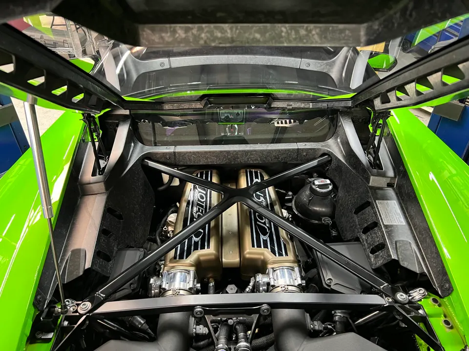 A detailed view of a Jotech-tuned Lamborghini Huracan V10 engine bay with custom intake manifolds.