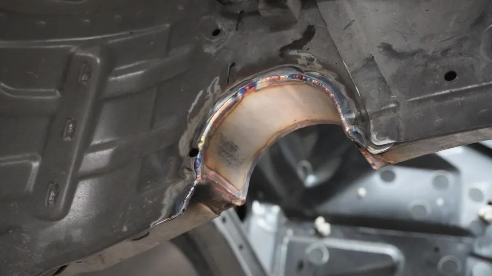 Close-up of custom chassis fabrication with welding on a performance car.