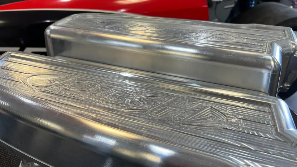 Close-up of polished billet valve covers with Jotech logo engraving, likely for a high-performance engine.