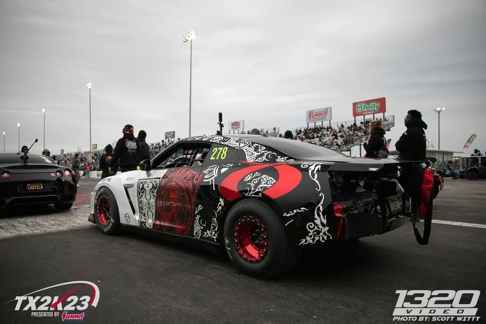 Highly modified Nissan GT-R drag car with custom livery and drag slicks at the TX2K drag strip event.