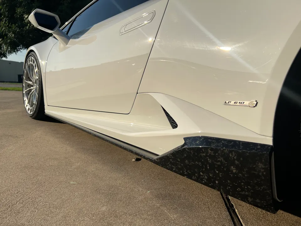 White Lamborghini Huracan LP 610-4 with forged carbon side skirts and custom multi-spoke wheels.