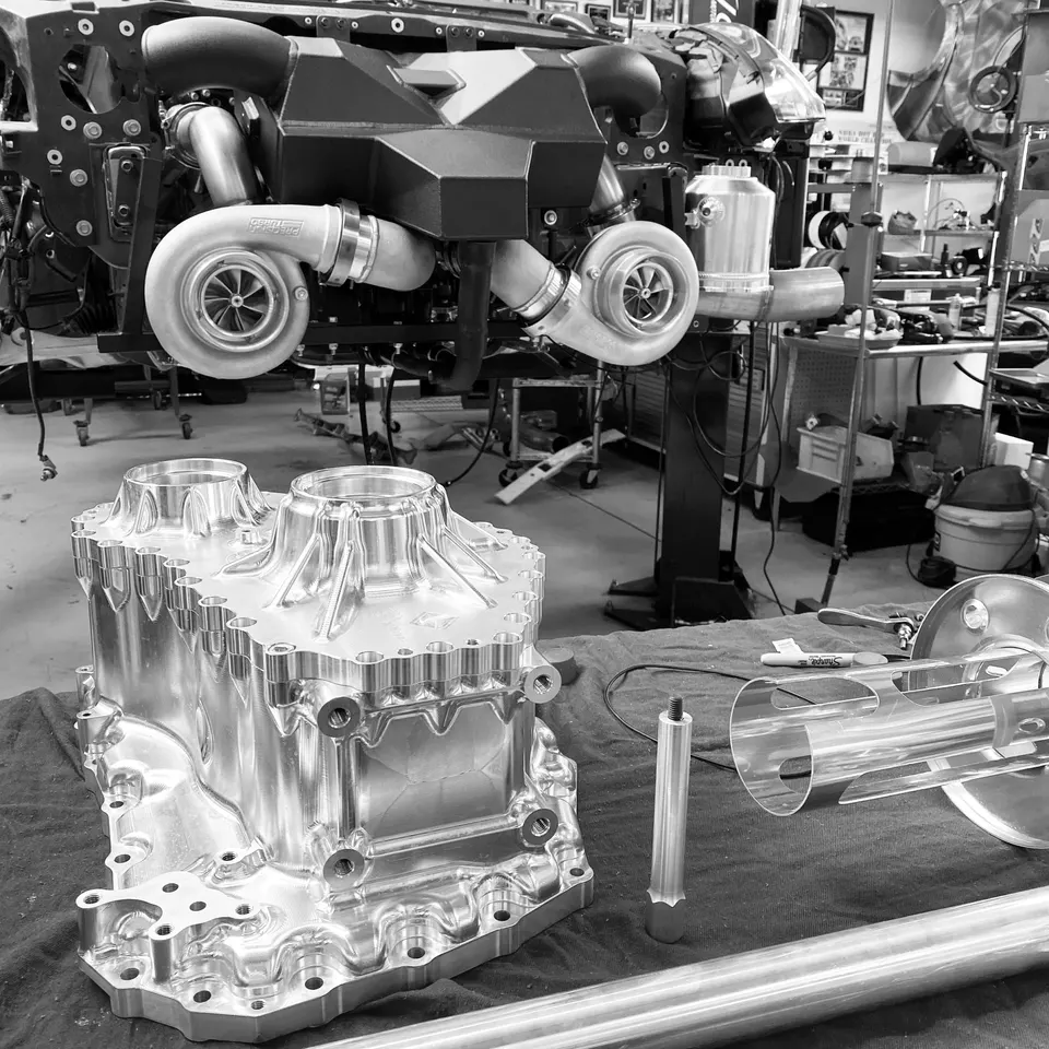 Twin turbochargers and custom billet engine components in a performance tuning shop.
