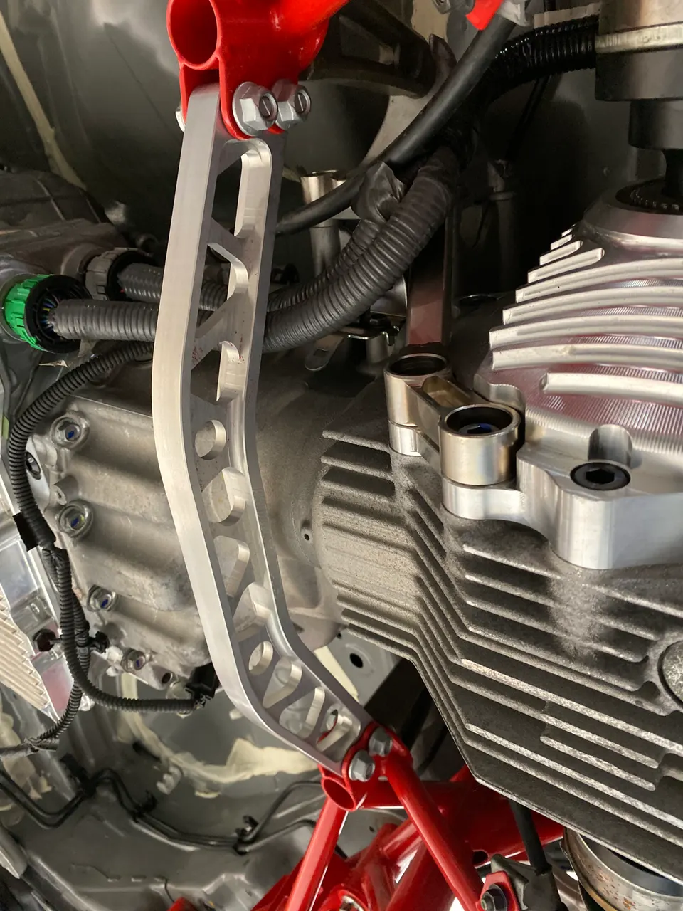 Close-up of a performance transmission or differential with an aftermarket chassis brace installed.