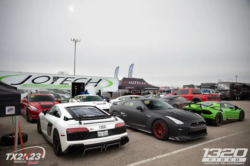 High-performance Audi R8, Nissan GT-R, and Lamborghini Huracan parked in the Jotech Motorsports paddock at TX2K23.