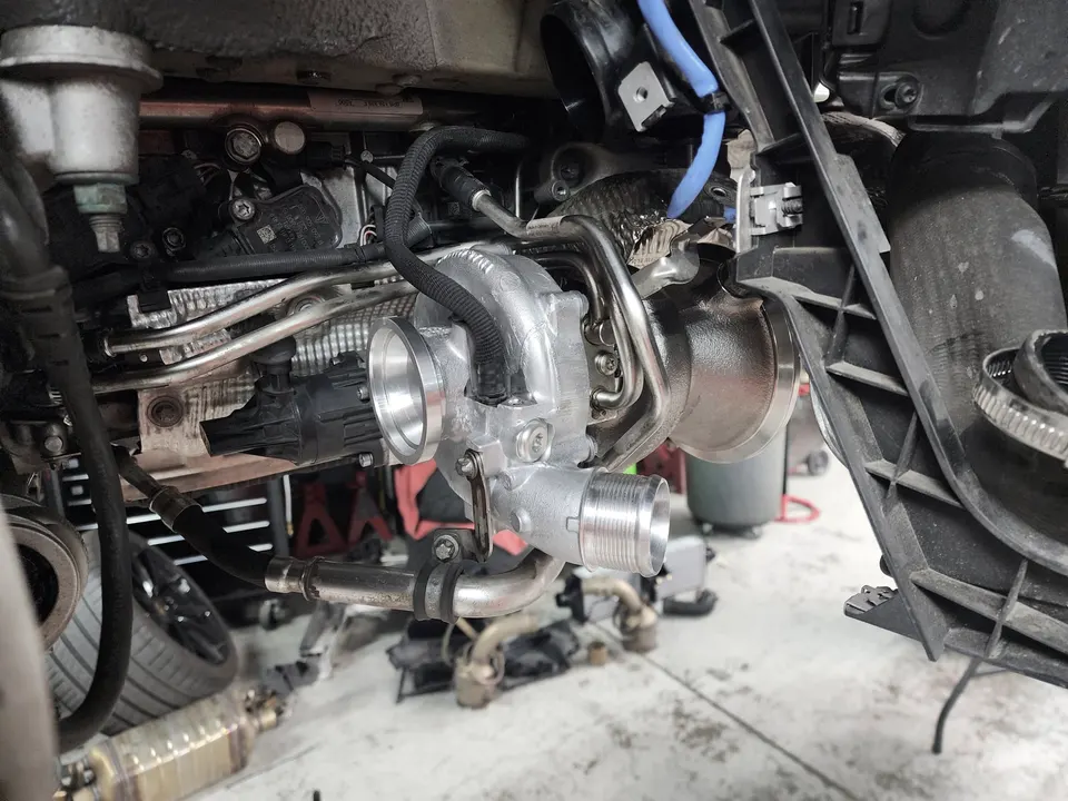Close-up view of a performance turbocharger installed in an engine bay during a build at Jotech Motorsports.