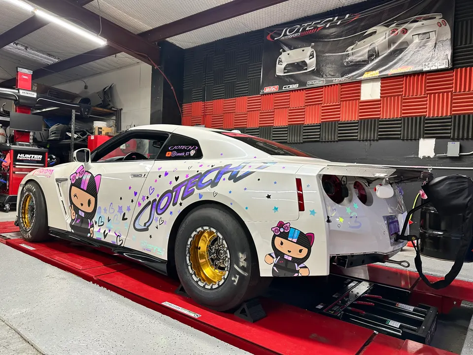 White Nissan GT-R drag car with custom livery on a Jotech Motorsports dyno.