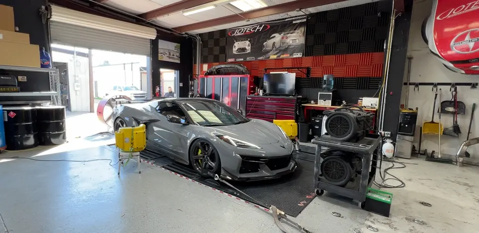 A grey Chevrolet Corvette C8 Z06 strapped to a dynamometer at Jotech Motorsports for performance tuning.