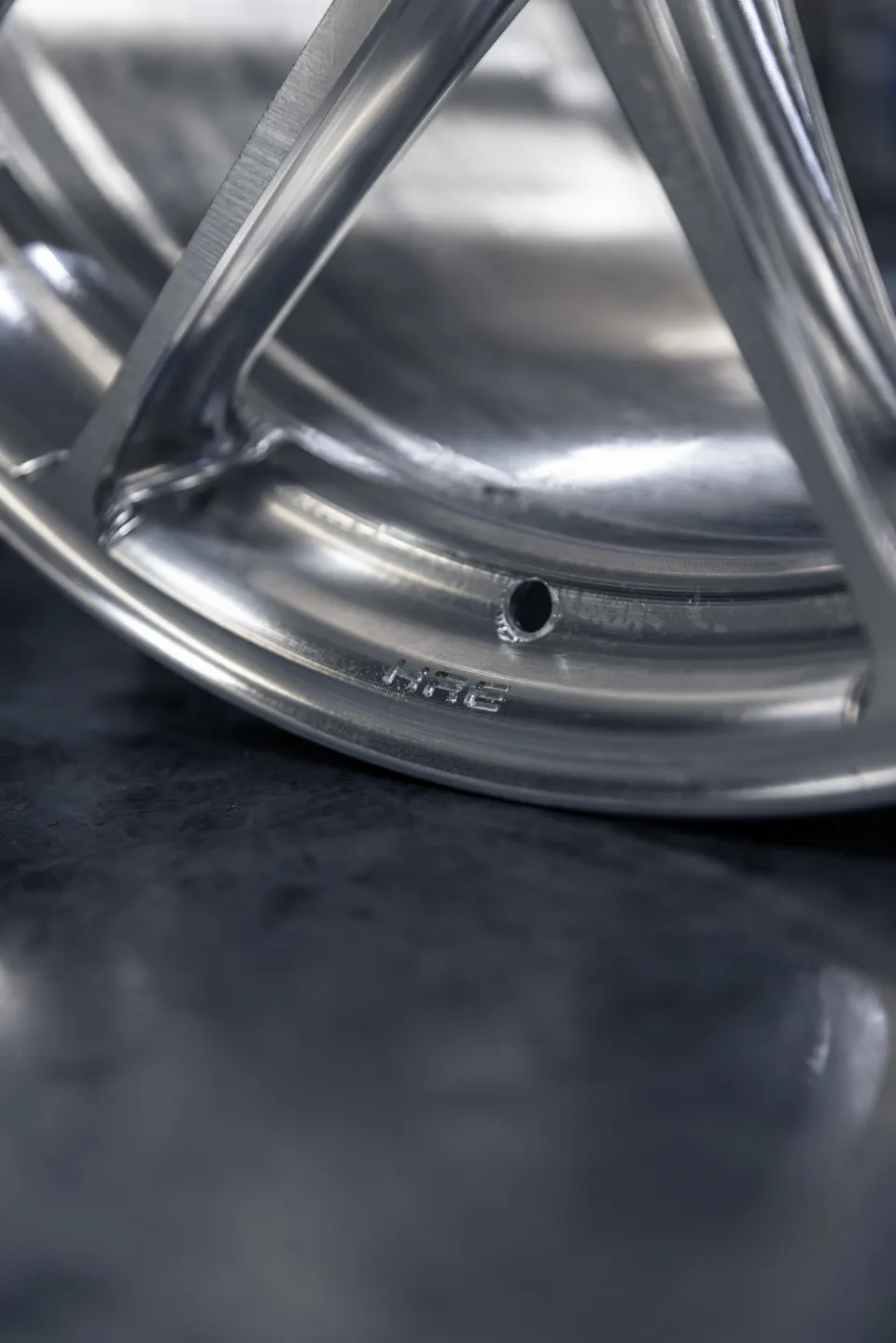 Close-up detail of a silver HRE performance wheel, showcasing its design and finish.
