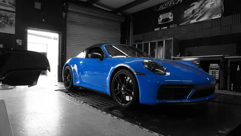 Blue Porsche 911 on a dyno at Jotech Motorsports performance tuning shop