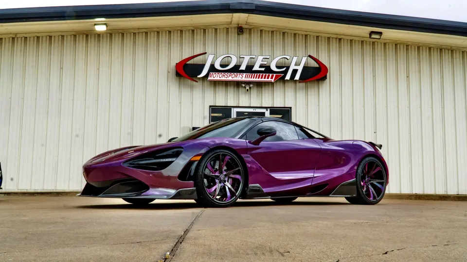 A custom purple McLaren 720S with aftermarket wheels parked outside Jotech Motorsports.