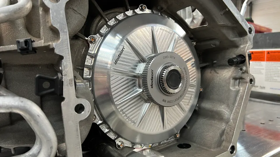 Close-up of a Dodson Promax DMS-3014 clutch assembly being installed in a performance vehicle transmission.