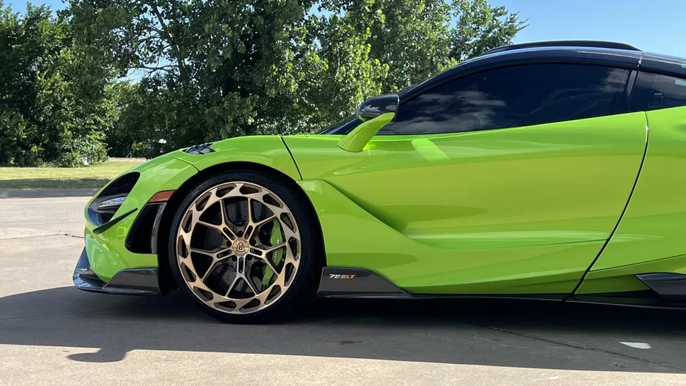 Lime green McLaren 765LT with custom forged wheels and carbon fiber aero elements parked outdoors.