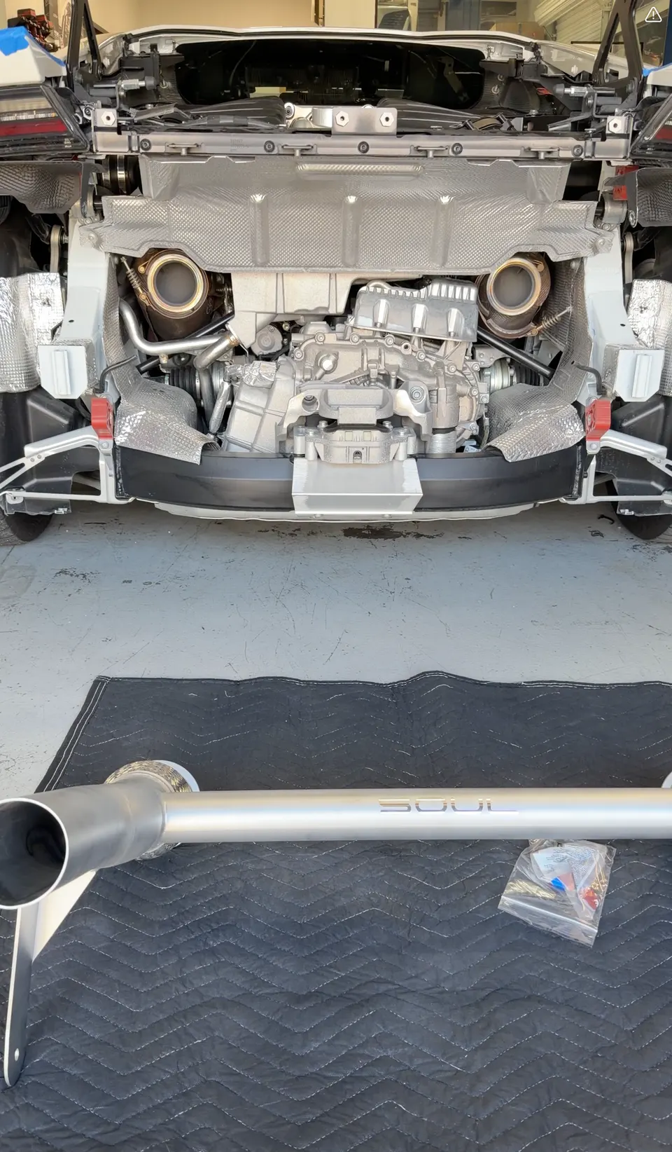 Rear view of a Porsche 911 with the exhaust system exposed, ready for a Soul Performance exhaust installation.