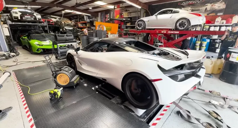 White McLaren 720S strapped to a dynamometer for performance tuning at Jotech Motorsports shop.